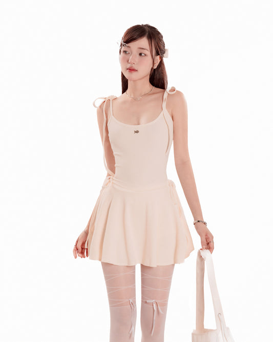 Woman wearing a beige dress with sheer stockings on a white background
