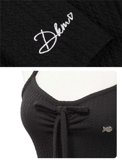 Black garment with 'Dkmv' logo on a white background