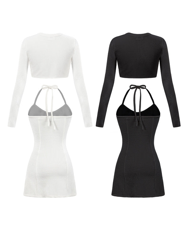 Black and white long-sleeve crop top and halter dress set on a white background