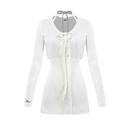 White ribbed cardigan with a tie detail on a white background