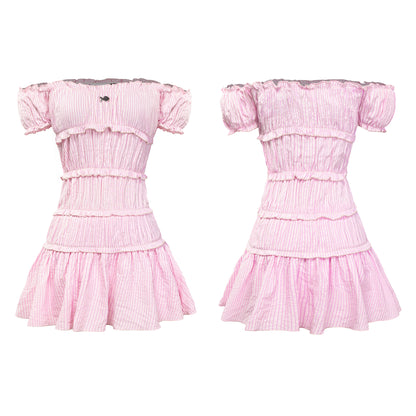 Pink dress with ruffled sleeves and layers on a white background