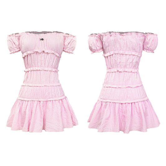 Pink dress with ruffled sleeves and layers on a white background
