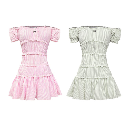 Two dresses, one pink and one green, on a white background