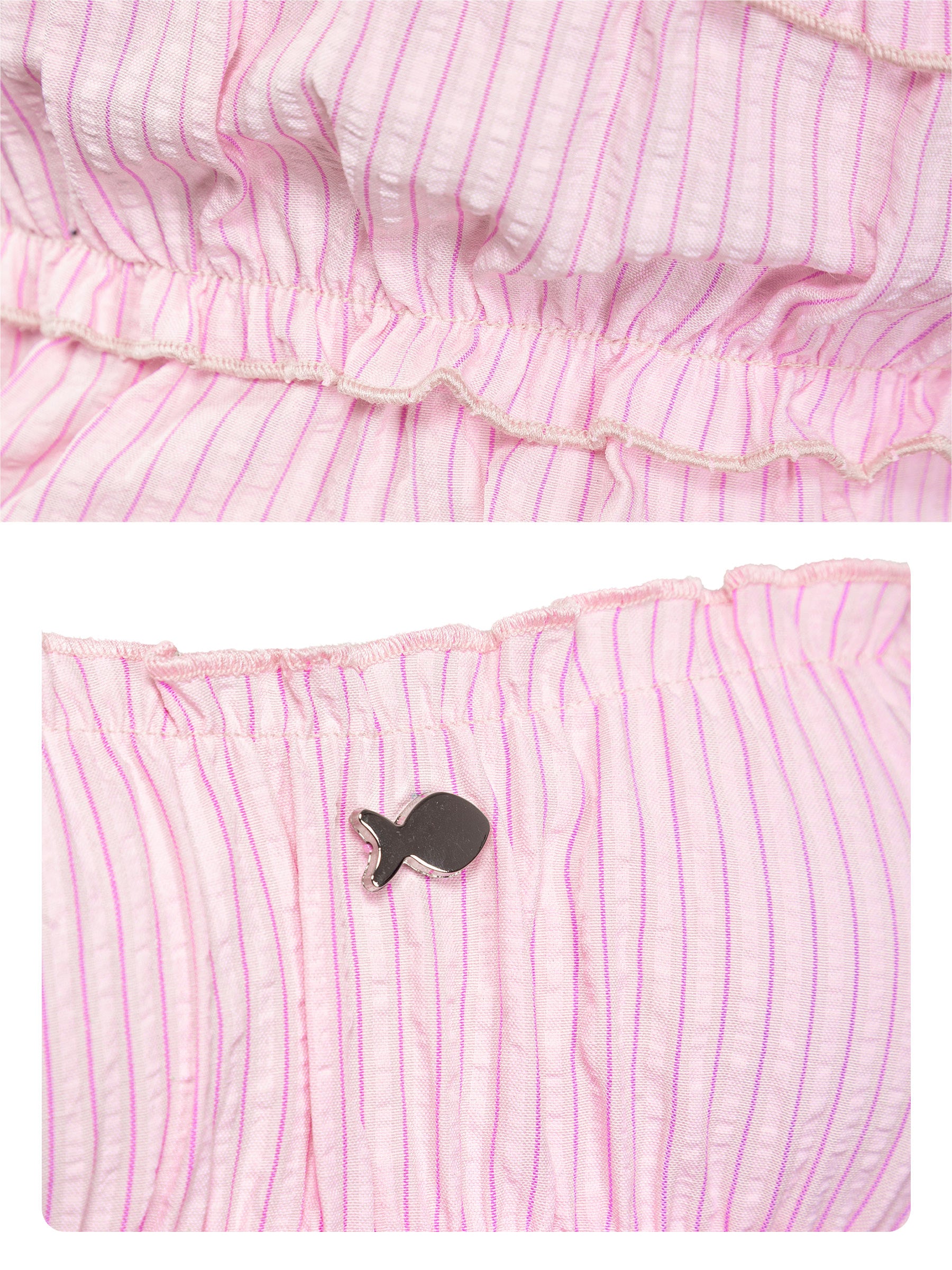 Pink striped fabric with a small black fish-shaped object on a white background