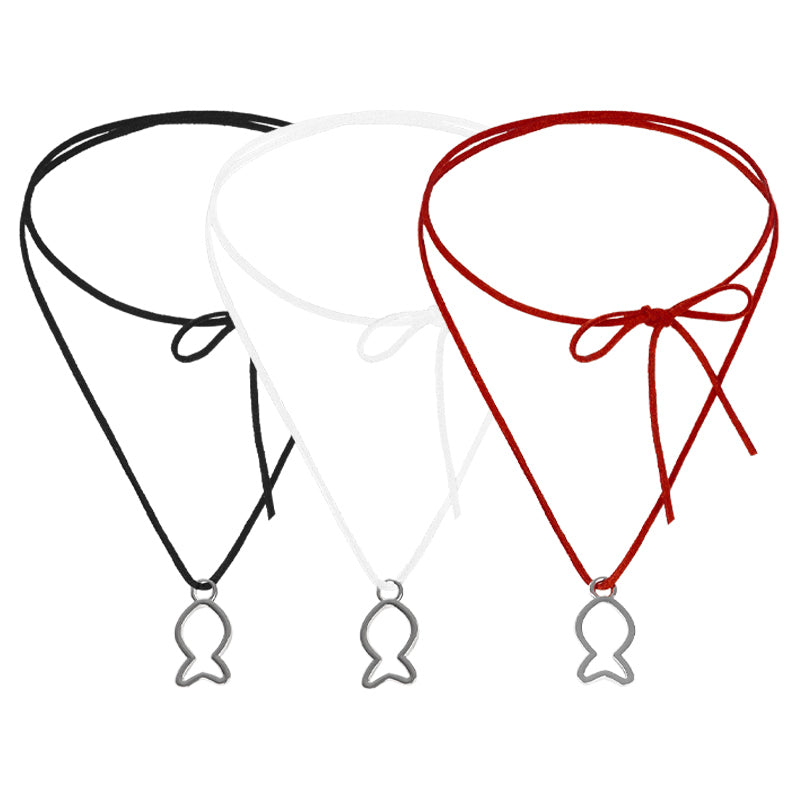 Three chokers in black, white, and red with fish pendants on a white background