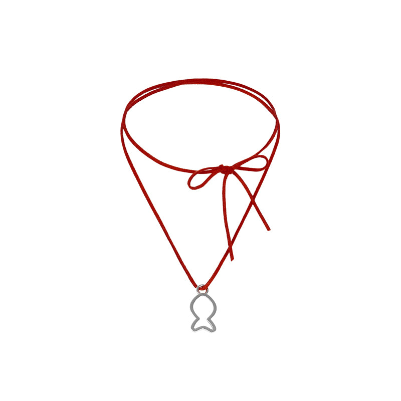 Red choker necklace with a silver fish pendant on a white background