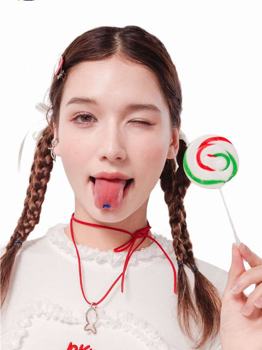 Person with pigtails holding a colorful lollipop against a white background