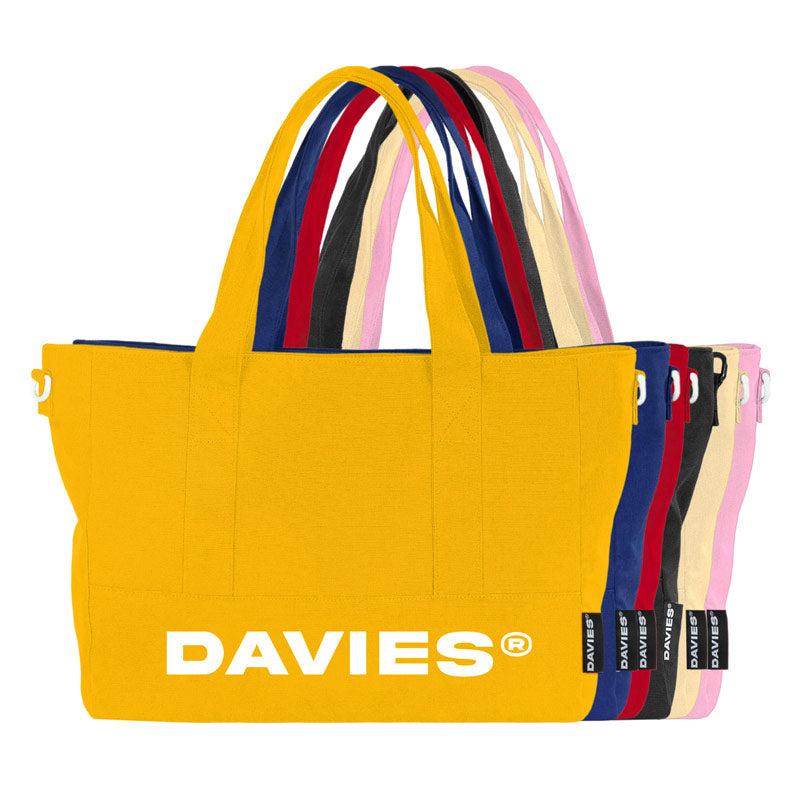 Yellow tote bag with colorful handles and 'DAVIES' branding on a white background